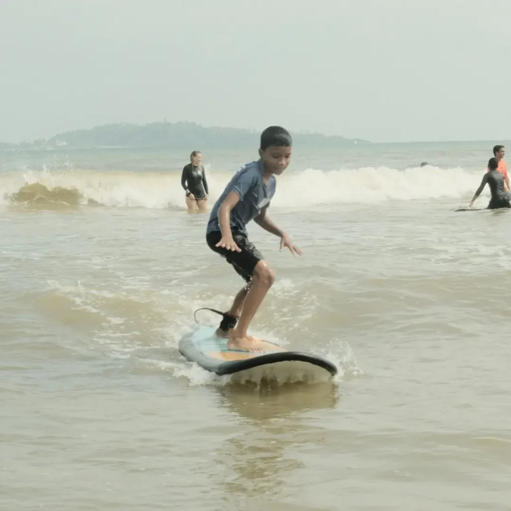 Kids learning surfing through Viji Surf community project